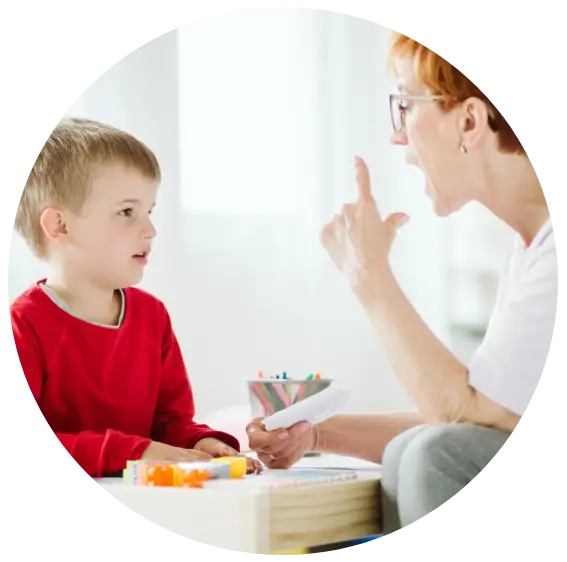 Little boy at the speech therapy with his teacher after school